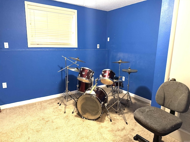 rec room with baseboards and carpet
