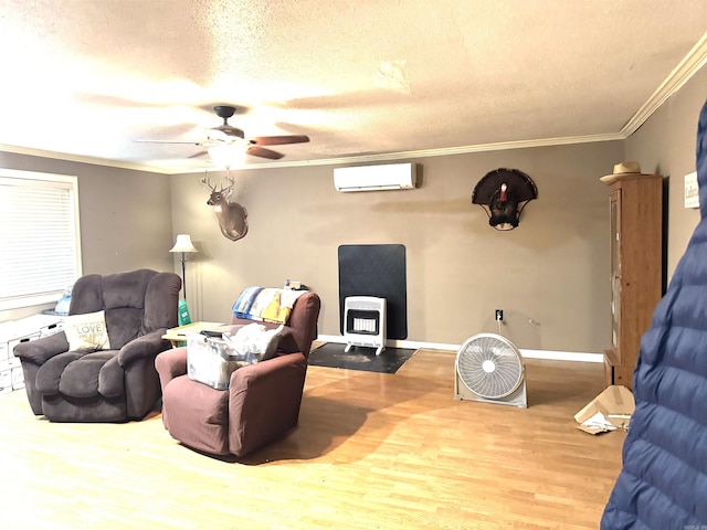 living area with a wall mounted AC, a wood stove, wood finished floors, crown molding, and ceiling fan
