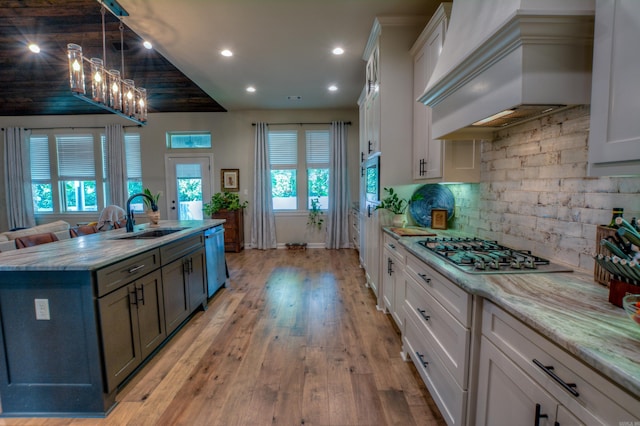 152 Callaway Cir, Hot Springs, AR 71913 - kitchen featuring appliances with stainless steel finishes, wall chimney exhaust hood, recessed lighting, a kitchen island with sink, and light stone countertops