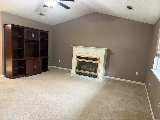 1008 Fox Ridge Dr, Benton, AR 72019 - unfurnished living room featuring a ceiling fan, lofted ceiling, light carpet, a textured ceiling, and a fireplace with flush hearth