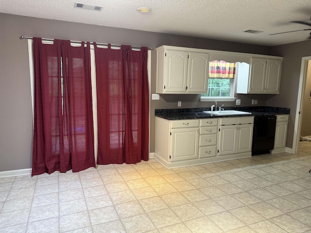 1008 Fox Ridge Dr, Benton, AR 72019 - kitchen featuring dishwasher, a textured ceiling, light floors, dark countertops, and white cabinets