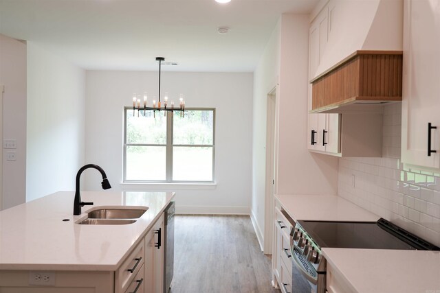 4013 Springwood Cir, Bryant, AR 72022 - kitchen with custom range hood, appliances with stainless steel finishes, a chandelier, tasteful backsplash, and light wood-style flooring