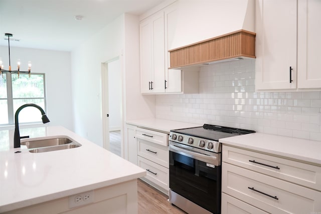 4013 Springwood Cir, Bryant, AR 72022 - kitchen featuring stainless steel range with electric stovetop, a chandelier, tasteful backsplash, light countertops, and light wood-style floors