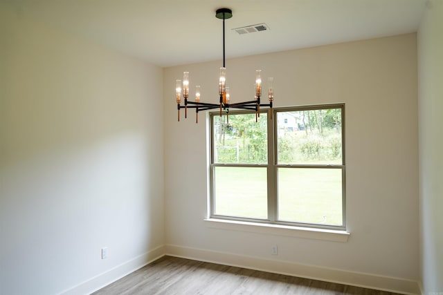 4013 Springwood Cir, Bryant, AR 72022 - unfurnished room featuring a chandelier, wood finished floors, and plenty of natural light