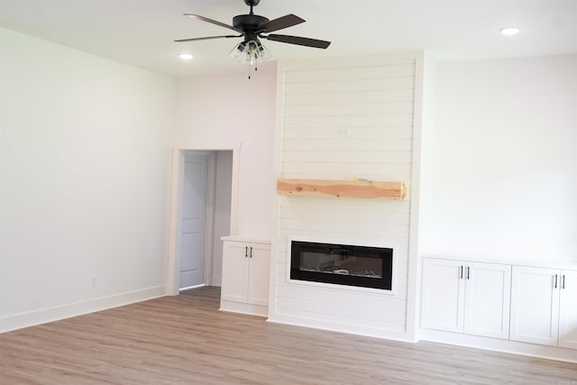 4013 Springwood Cir, Bryant, AR 72022 - unfurnished living room featuring light wood-style flooring, ceiling fan, a large fireplace, and recessed lighting