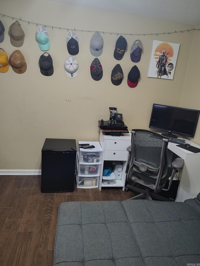 office space with wood finished floors and baseboards