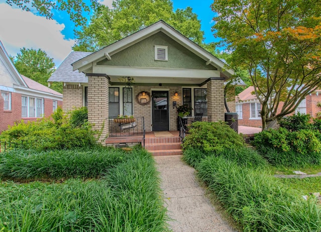 319 W G Ave, North Little Rock, AR 72116 - bungalow-style house featuring brick siding, covered porch, and stucco siding