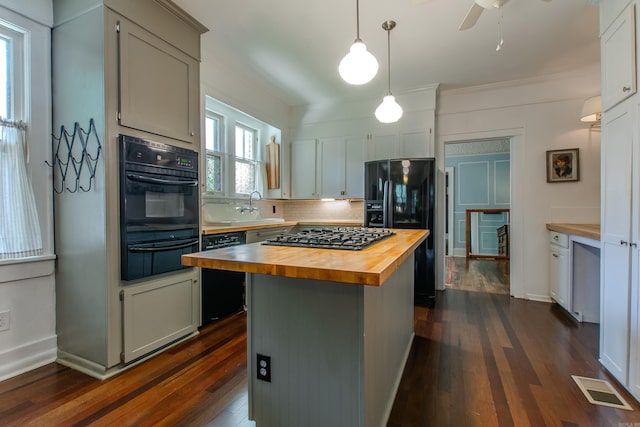 319 W G Ave, North Little Rock, AR 72116 - kitchen featuring wooden counters, black appliances, a warming drawer, dark wood-style flooring, and a center island