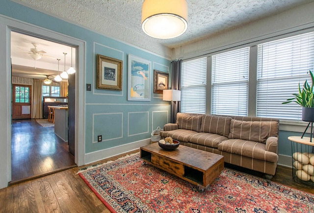 319 W G Ave, North Little Rock, AR 72116 - living area featuring wood finished floors, ceiling fan, and a textured ceiling
