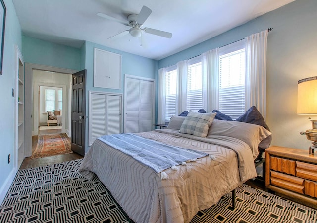 319 W G Ave, North Little Rock, AR 72116 - bedroom with multiple windows, a closet, a ceiling fan, and dark wood finished floors