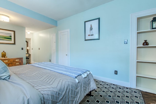 319 W G Ave, North Little Rock, AR 72116 - bedroom featuring arched walkways and dark wood finished floors