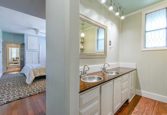319 W G Ave, North Little Rock, AR 72116 - ensuite bathroom featuring ornamental molding, wood finished floors, ceiling fan, double vanity, and healthy amount of natural light