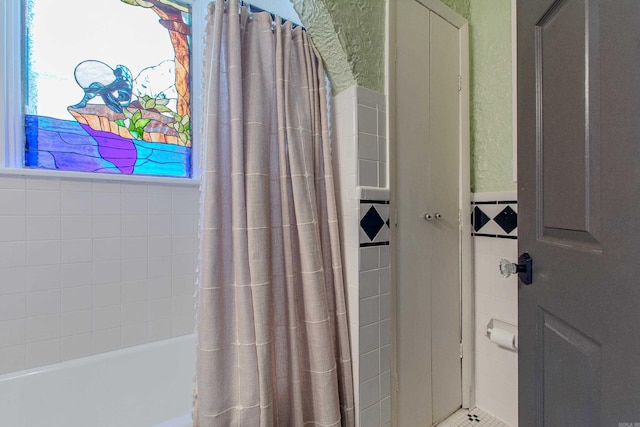 319 W G Ave, North Little Rock, AR 72116 - bathroom with tile walls and shower / bath combo