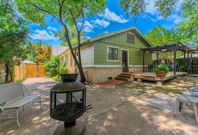 319 W G Ave, North Little Rock, AR 72116 - rear view of property with a pergola, a gate, brick siding, board and batten siding, and a patio area