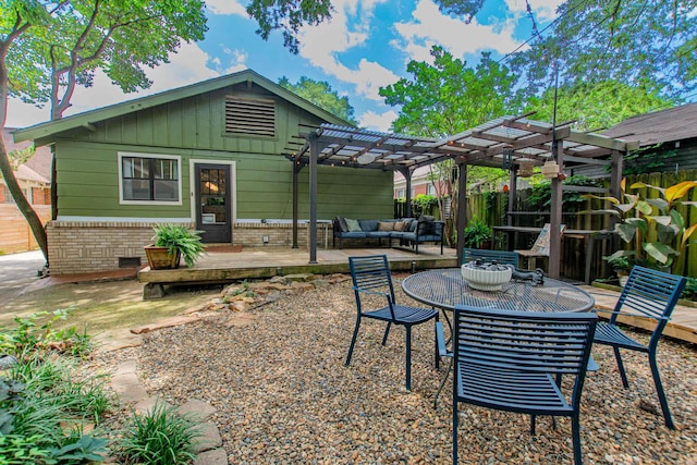 319 W G Ave, North Little Rock, AR 72116 - rear view of house with a pergola, outdoor lounge area, a patio, and board and batten siding