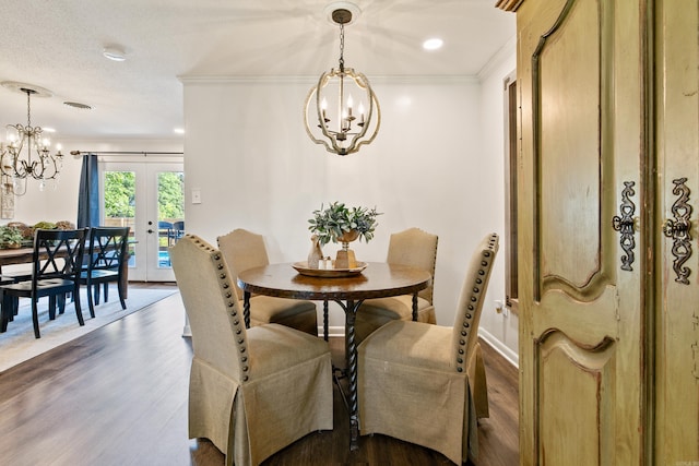 520 E 8th St, Lonoke, AR 72086 - dining area featuring a chandelier, french doors, ornamental molding, and dark wood-type flooring