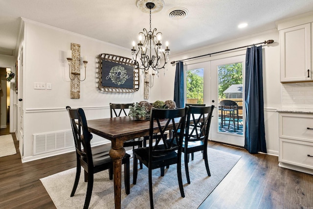 520 E 8th St, Lonoke, AR 72086 - dining room with ornamental molding, french doors, dark wood finished floors, a chandelier, and a textured ceiling