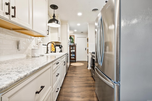 520 E 8th St, Lonoke, AR 72086 - kitchen featuring appliances with stainless steel finishes, tasteful backsplash, dark wood-style floors, pendant lighting, and recessed lighting
