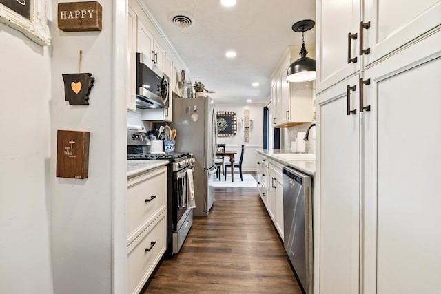 520 E 8th St, Lonoke, AR 72086 - kitchen featuring stainless steel appliances, recessed lighting, white cabinetry, dark wood-style floors, and decorative light fixtures
