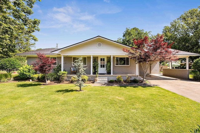 520 E 8th St, Lonoke, AR 72086 - view of front of house with brick siding, driveway, a front yard, and covered porch