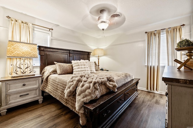 520 E 8th St, Lonoke, AR 72086 - bedroom with dark wood-style floors and a ceiling fan
