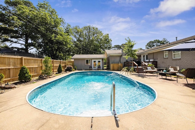 520 E 8th St, Lonoke, AR 72086 - view of swimming pool featuring a fenced backyard, a wooden deck, an outdoor living space, a patio, and french doors