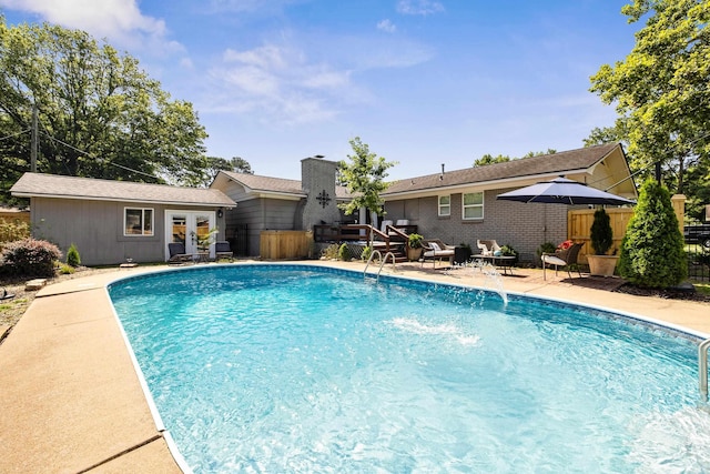520 E 8th St, Lonoke, AR 72086 - view of swimming pool with french doors, an outdoor structure, and a patio area