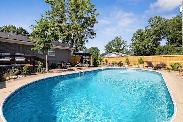 520 E 8th St, Lonoke, AR 72086 - view of swimming pool with a fenced backyard, a wooden deck, and a patio area