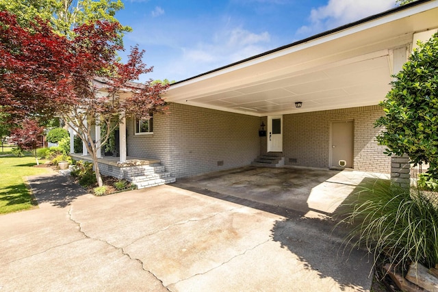 520 E 8th St, Lonoke, AR 72086 - view of patio featuring entry steps, driveway, and a carport