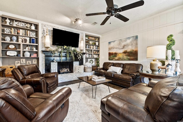 520 E 8th St, Lonoke, AR 72086 - living area featuring wood finished floors, a textured ceiling, built in features, ceiling fan, and a fireplace