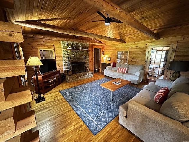 410 S Riverview Ln, Mountain View, AR 72560 - living area with a wood ceiling with exposed beams, wood walls, hardwood / wood-style flooring, ceiling fan, and a fireplace