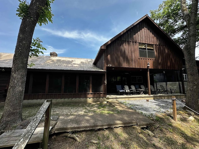 410 S Riverview Ln, Mountain View, AR 72560 - rear view of house with a sunroom, a patio area, and a metal roof