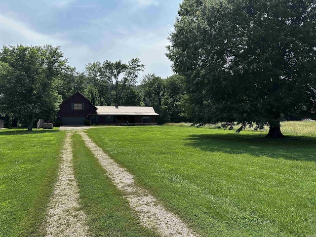 410 S Riverview Ln, Mountain View, AR 72560 - view of green lawn featuring driveway, a garage, and a barn