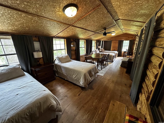 410 S Riverview Ln, Mountain View, AR 72560 - bedroom featuring dark wood-style floors, vaulted ceiling, and wooden walls
