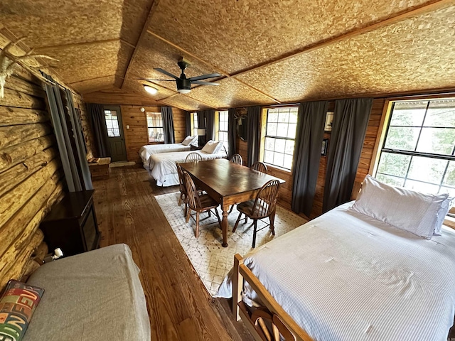410 S Riverview Ln, Mountain View, AR 72560 - bedroom featuring vaulted ceiling, multiple windows, hardwood / wood-style flooring, and wood walls
