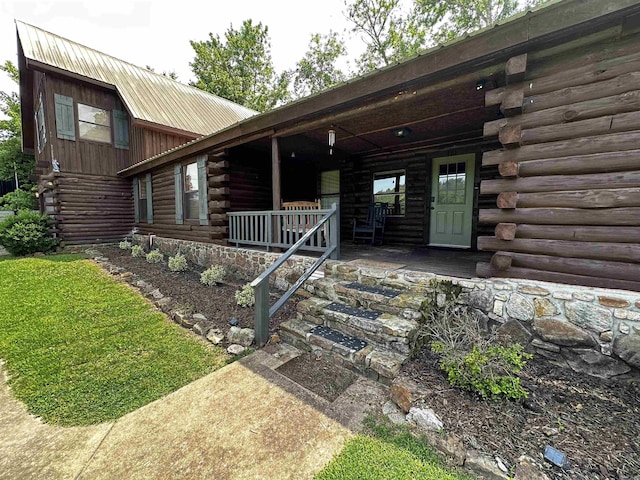 410 S Riverview Ln, Mountain View, AR 72560 - view of front facade with log exterior, a porch, and a metal roof
