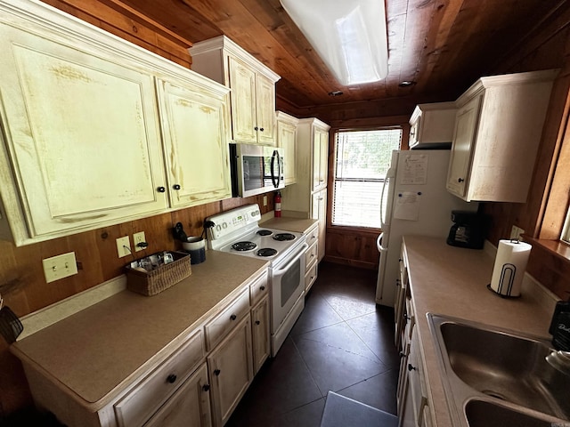 410 S Riverview Ln, Mountain View, AR 72560 - kitchen with white range with electric stovetop, stainless steel microwave, wood walls, wood ceiling, and light countertops