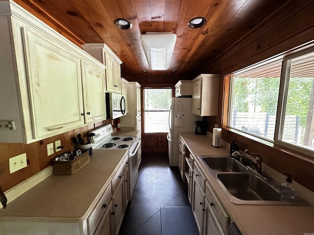 410 S Riverview Ln, Mountain View, AR 72560 - kitchen with electric stove, wooden ceiling, stainless steel microwave, dark tile patterned flooring, and light countertops