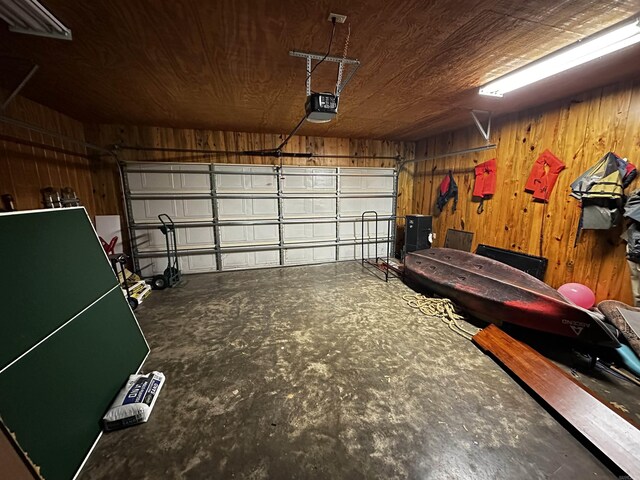 410 S Riverview Ln, Mountain View, AR 72560 - garage with wood walls and a garage door opener