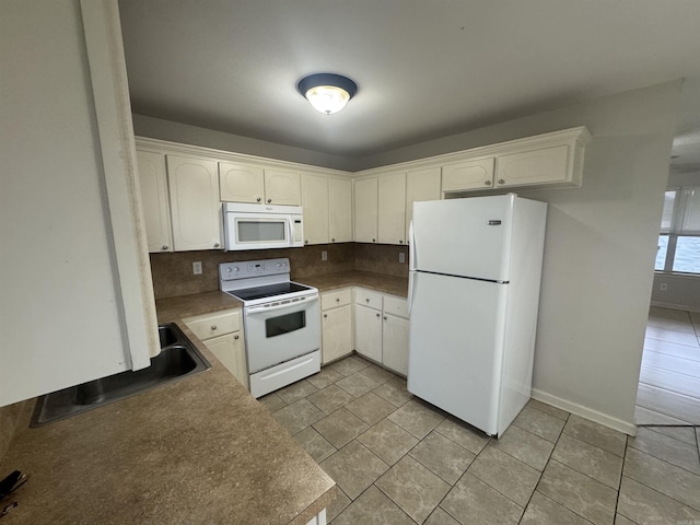 1010 Tori Ln, Beebe, AR 72012 - kitchen with white appliances, tasteful backsplash, and white cabinets