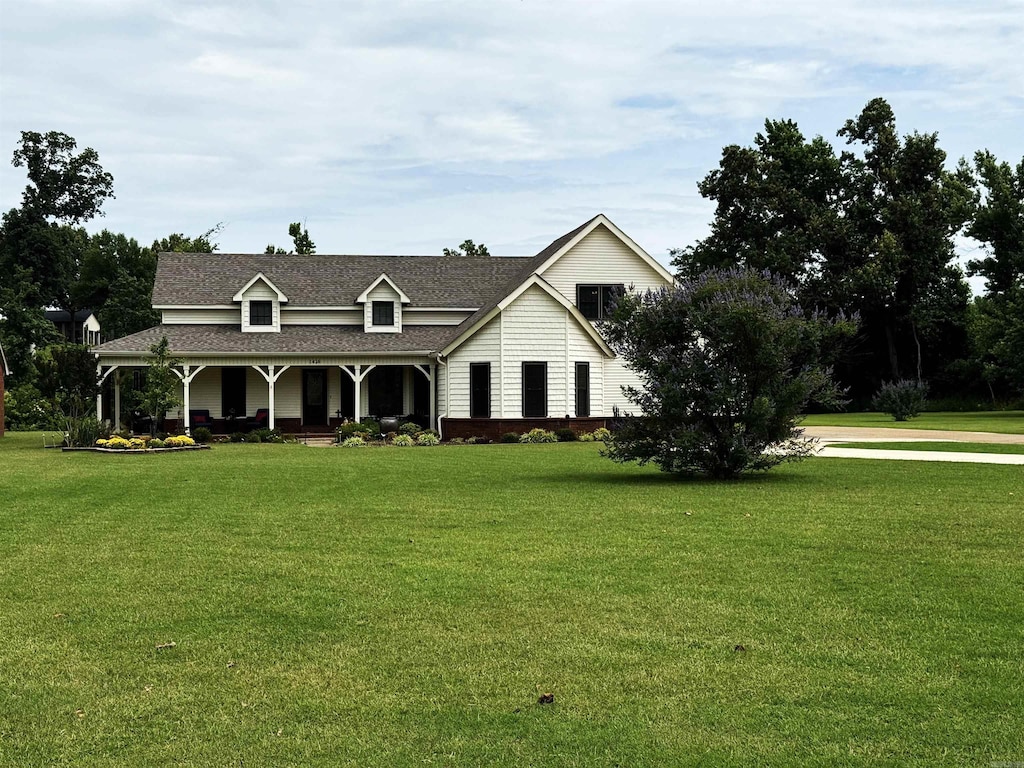 1426 Airpark Rd, Wynne, AR 72396 - view of front facade featuring covered porch, a front yard, and a shingled roof