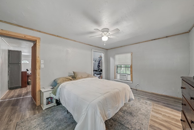 172 Susie Ln, Mena, AR 71953 - bedroom with wood finished floors, a walk in closet, a closet, and a ceiling fan
