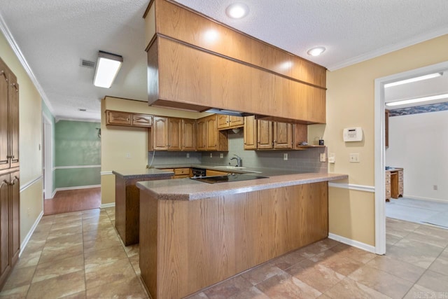 3905 Deer Dr, Benton, AR 72019 - kitchen with a peninsula, crown molding, a textured ceiling, decorative backsplash, and brown cabinetry