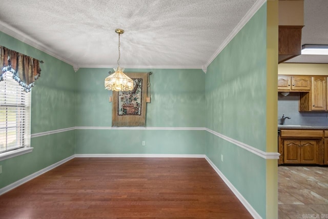 3905 Deer Dr, Benton, AR 72019 - unfurnished dining area featuring a chandelier, crown molding, a textured ceiling, and light wood-style flooring