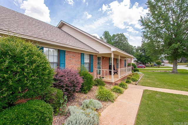 3905 Deer Dr, Benton, AR 72019 - view of side of property featuring covered porch, brick siding, a lawn, and a shingled roof