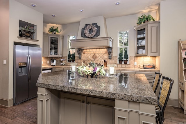 12 Cobblestone Way, Little Rock, AR 72223 - kitchen with stainless steel refrigerator with ice dispenser, dark wood-style floors, decorative backsplash, glass insert cabinets, and recessed lighting