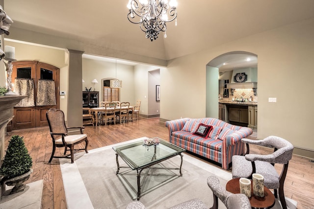 12 Cobblestone Way, Little Rock, AR 72223 - living room with light wood-type flooring, arched walkways, a chandelier, and lofted ceiling