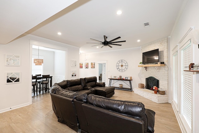 2072 Creekwood Cir, Bauxite, AR 72011 - living room with crown molding, light wood-style flooring, a ceiling fan, a fireplace, and recessed lighting