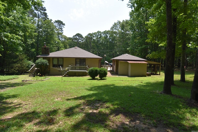 230 Spring St, Fairfield Bay, AR 72088 - rear view of property with a lawn, a chimney, and an outdoor structure