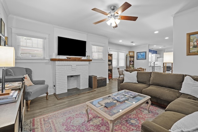 100 Melrose Dv, North Little Rock, AR 72114 - living room featuring wood finished floors, ornamental molding, ceiling fan, a brick fireplace, and recessed lighting
